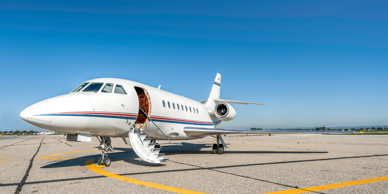 private jet on tarmac on sunny day