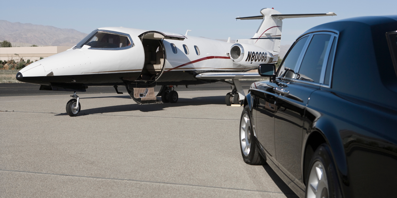 private jet with private car on tarmac